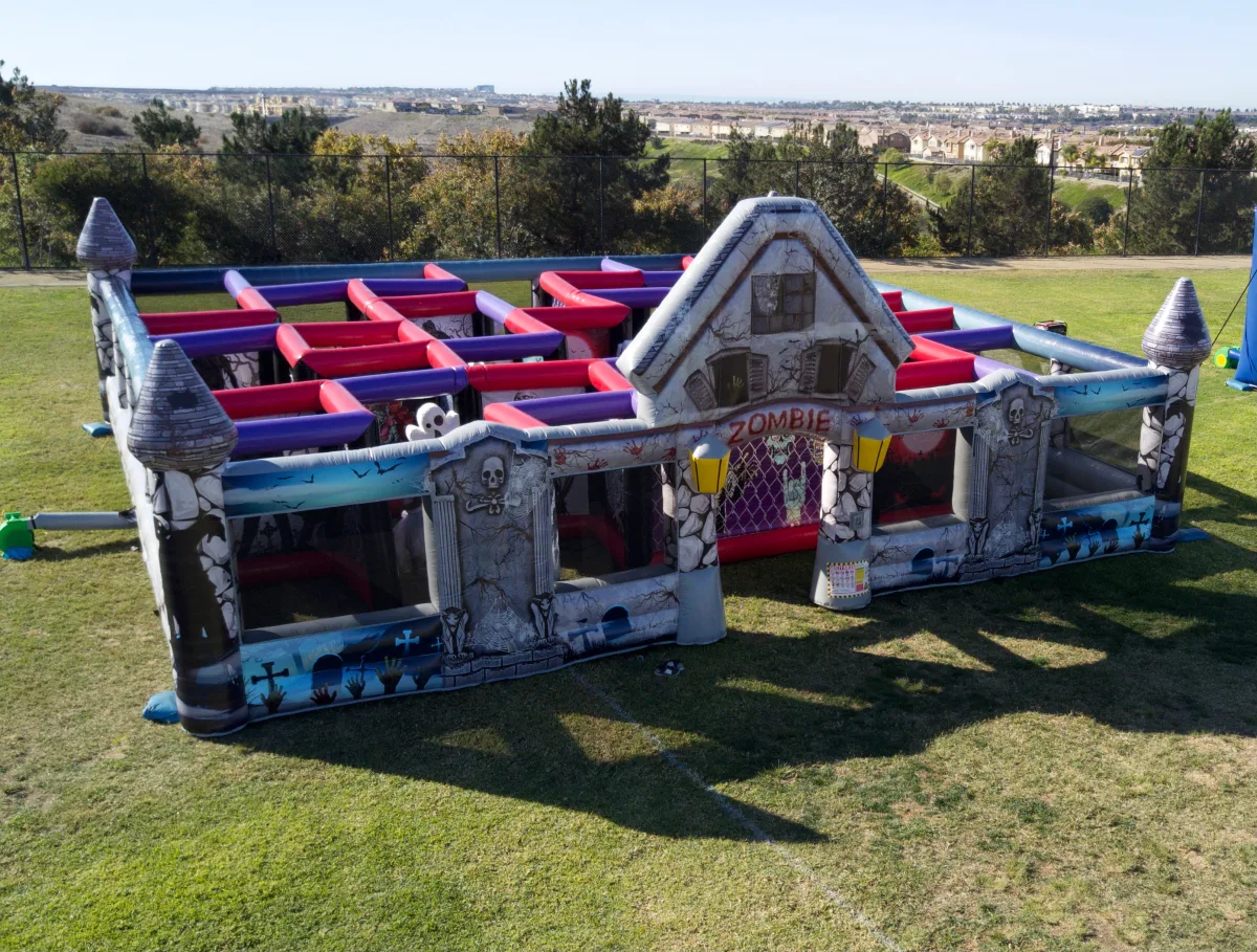 Aerial view of the inflatable Zombie Maze walk-through attraction set up on a grass field, one of the Halloween attractions available for La Cañada Flintridge events